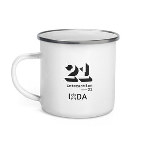 White enamel mug with chrome rim. Black Interaction 21 and IxDA logos on side.