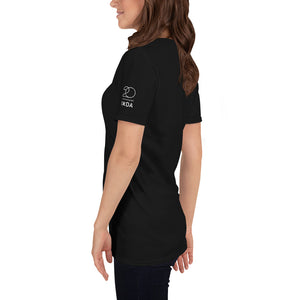 Woman from the side wearing black T-shirt with white Interaction 20/IxDA logo on the left sleeve.  