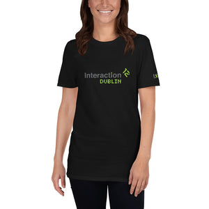 Woman in black T-shirt with grey and  green IxDA logo on the right sleeve