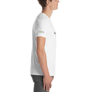 Man in white T-shirt with grey and  green IxDA logo on the right sleeve